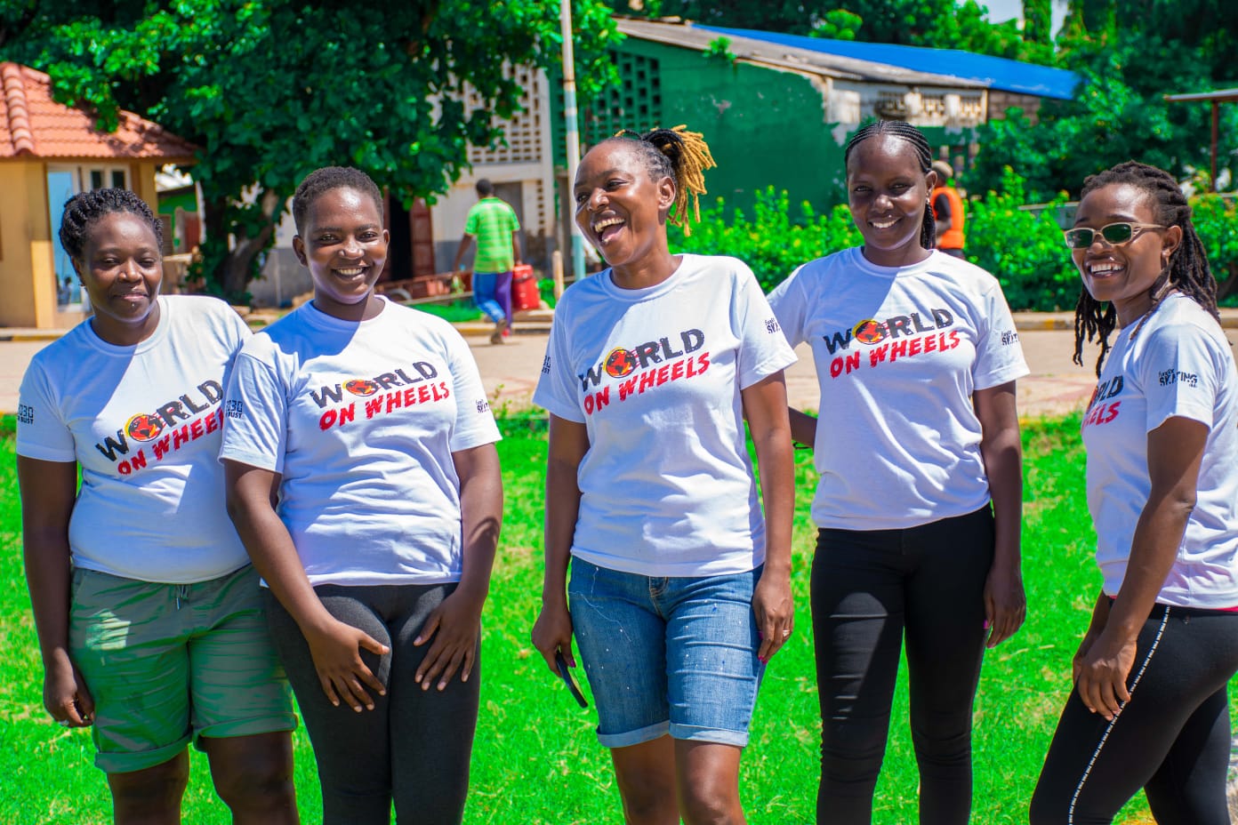 women wearing world on wheels t shirts